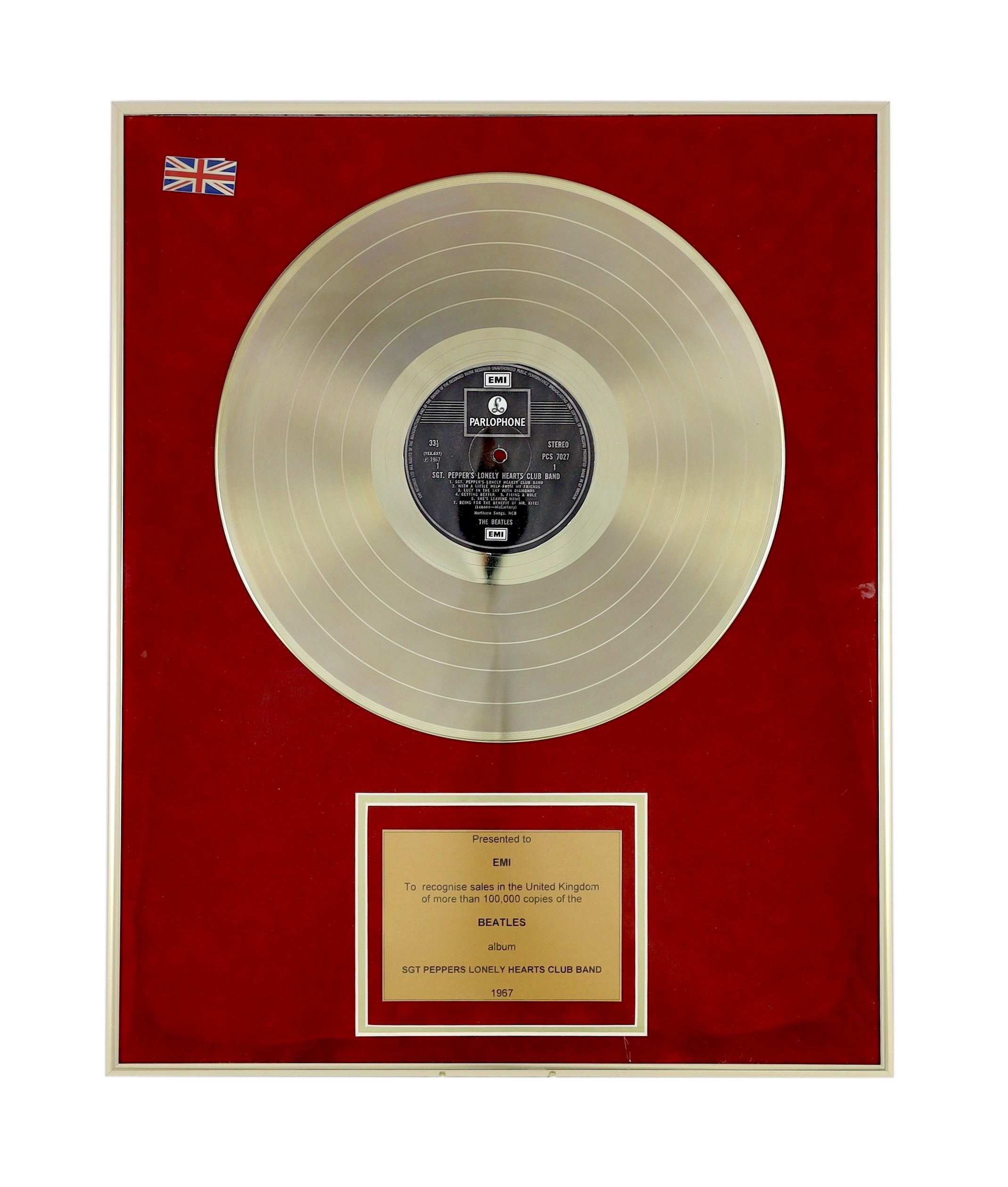 Sgt. Peppers Lonely Hearts Club Band, a framed gold disc, presented to EMI to recognise sales in the United Kingdom, of more than 100,000 copies, frame 41 x 50cm